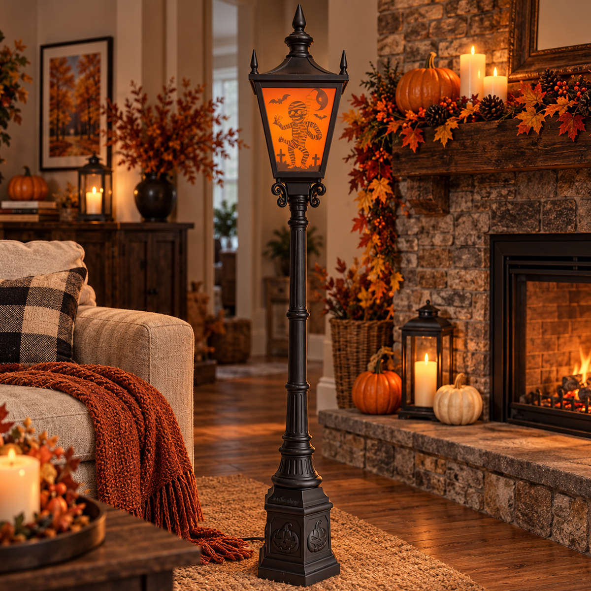 Black Halloween lamp post with an orange mummy panel and jack-o'-lantern base, displayed in a fall-decorated living room.