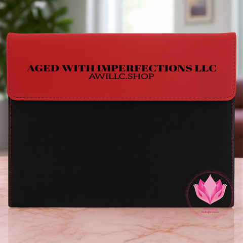 Black leatherette portfolio with a red flap engraved with a business name.