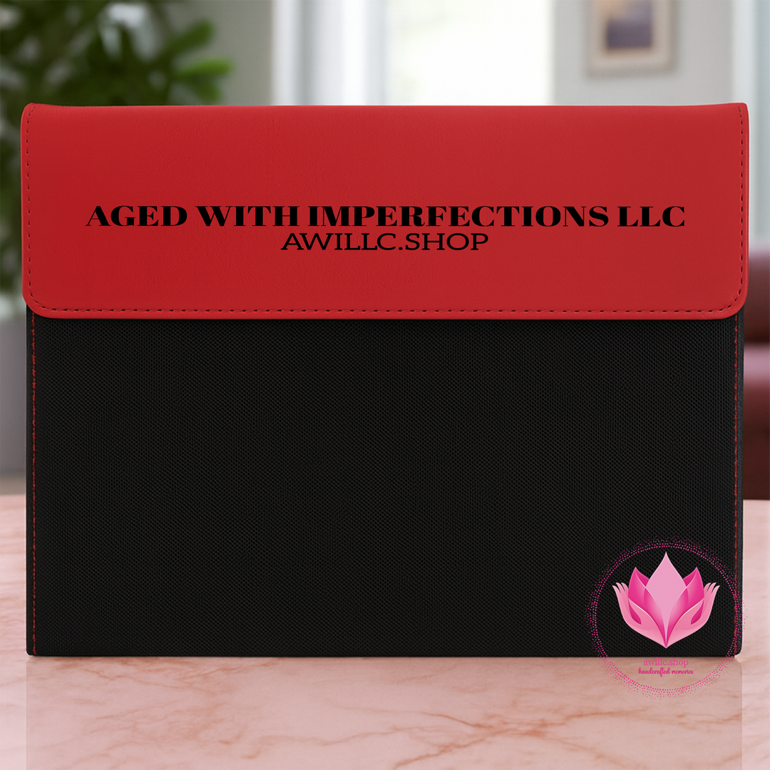Black leatherette portfolio with a red flap engraved with a business name.