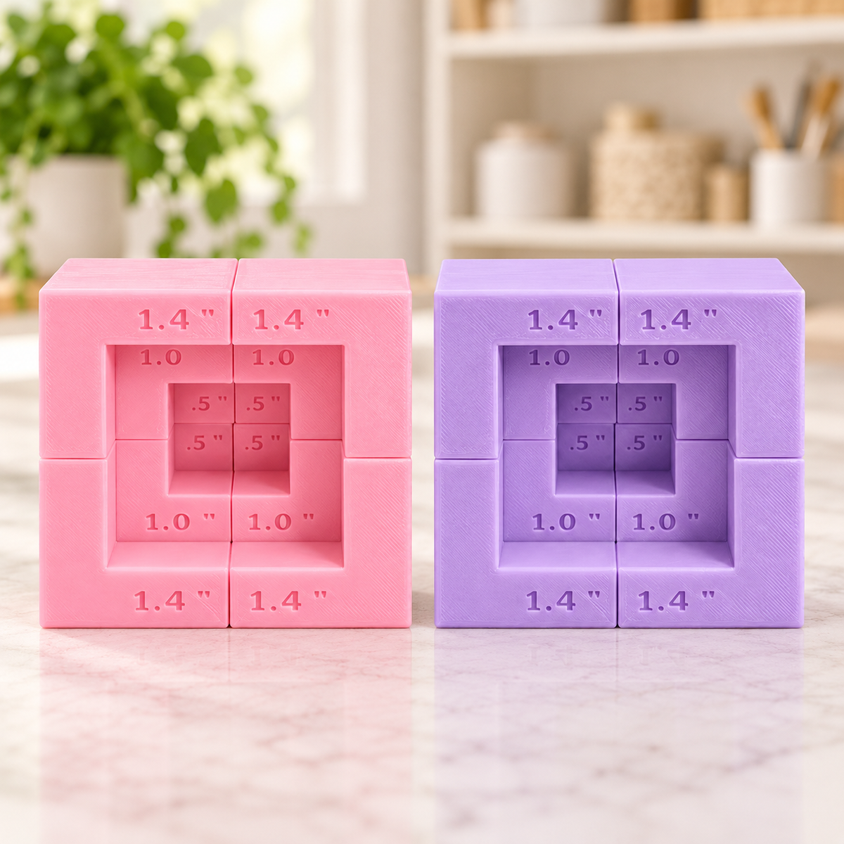 Pink and lavender 3D printed magnetic laser riser blocks arranged in nested squares with height markings on a marble-look counter.