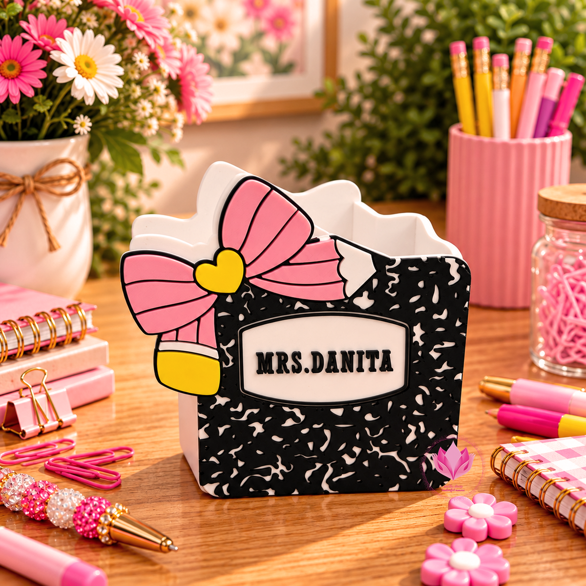 Black and white composition notebook inspired storage box personalized with a teacher name and colorful decorative bow.