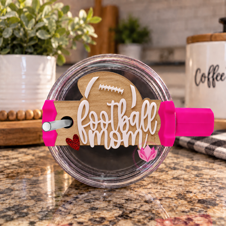 Football Mom acrylic tumbler topper designed for a Stanley H2.0 Quencher tumbler.