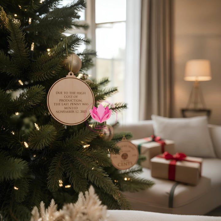 Decorative keepsake ornament showcasing a real U.S. penny set into an engraved round design commemorating American currency history.