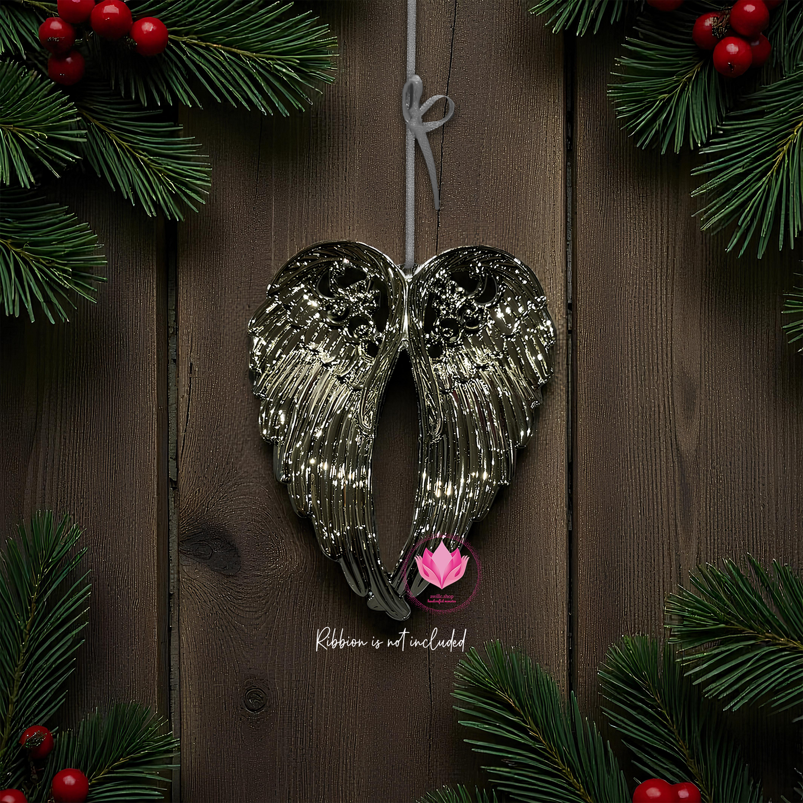 Metallic silver angel wings ornament with intricate feather detail and hanging string shown against a plain background.