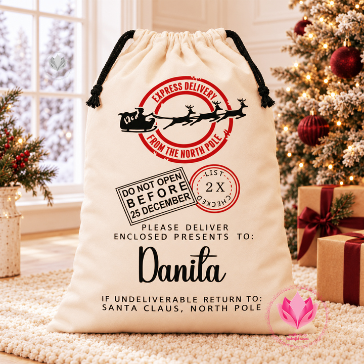 Personalized cream Santa delivery canvas gift sack with custom name and North Pole Christmas design.