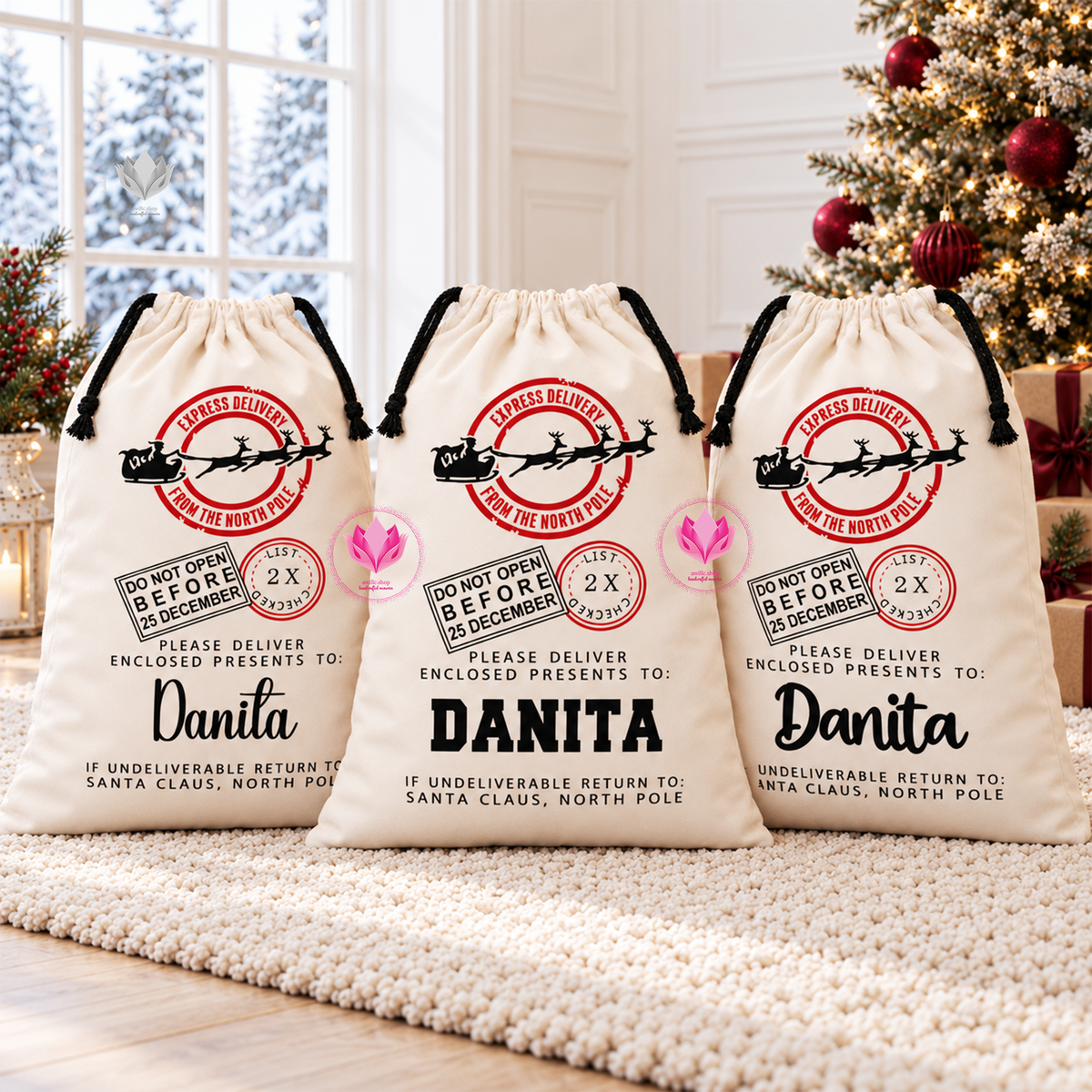 Group display of personalized cream Santa canvas gift sacks with custom names for Christmas gifts.