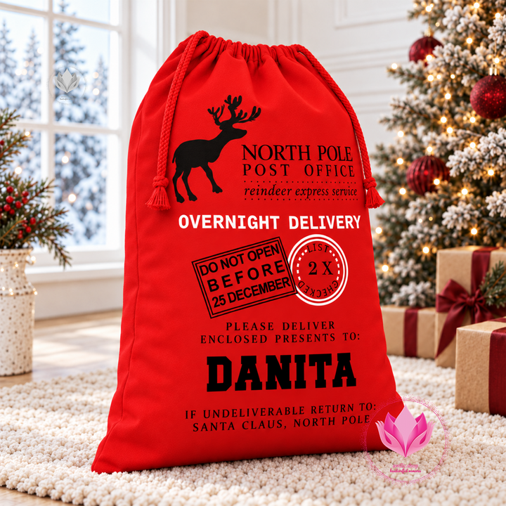 Personalized red Santa delivery canvas gift sack with custom name and North Pole Christmas design.