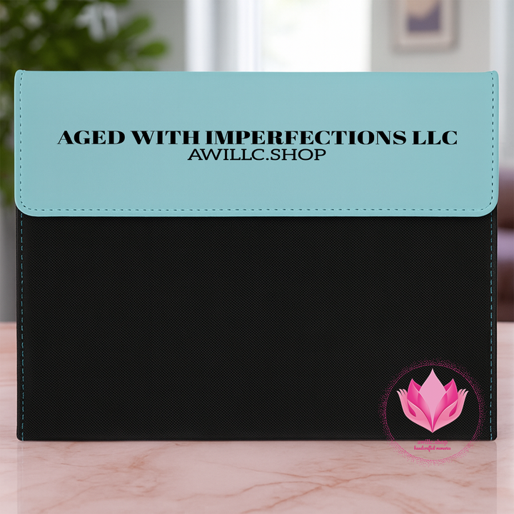 Engraved Portfolio  and black pouch with 'Aged with Imperfections LLC' text and pink lotus logo.