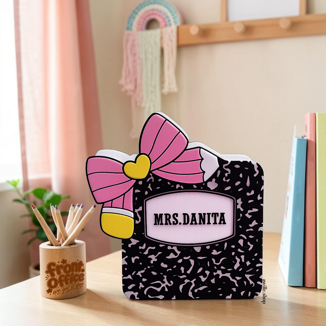 Personalized black and pink composition notebook teacher box with large pink bow, pencil accent and custom name.